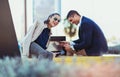 Couple sitting on solar bench and charges phone Royalty Free Stock Photo