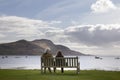 Couple sitting staring at Holy Isle on Arran