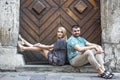 Couple sitting on the steps of the old house. Portrait of loving couple, young family.