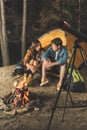 couple sitting in tent on hiking trip with telescope Royalty Free Stock Photo