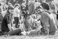 A couple sitting with their dog in the park at a dog show