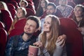 Couple sitting together in cinema, watching comedy. Royalty Free Stock Photo