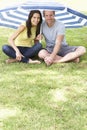 Couple Sitting Under Garden Umbrella