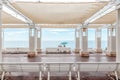 Couple sitting on a white bench under a gazebo by the beach Royalty Free Stock Photo