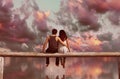 Couple sitting on wooden fence with colorful sky background