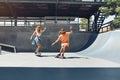 Couple On Skateboards Portrait. Happy Guy And Girl In Casual Outfit Riding At Skatepark Royalty Free Stock Photo