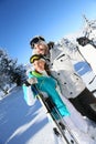 Couple of skiers looking at snowy scenery in the mountains