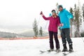 Couple of skiers on slope at resort, space for text. Royalty Free Stock Photo