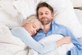 Couple Sleeping Together In Bed