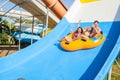 Couple sliding down a water slide Royalty Free Stock Photo