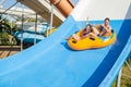 Couple sliding down a water slide Royalty Free Stock Photo