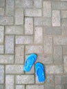 Couple of small flip-flops on a paving bed Royalty Free Stock Photo
