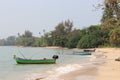 a couple of small green boats on a beach next to the ocean Royalty Free Stock Photo