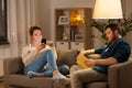 Couple with smartphone and book at home