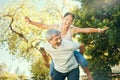 Couple, smile and piggyback in nature for fun, excited and playful in freedom, energy and joy. Happy elderly asian