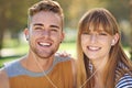 Couple, smile in portrait and earphones outdoor for music and entertainment, technology and romantic date in park Royalty Free Stock Photo