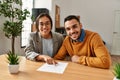 Couple smiling happy reading document at the office Royalty Free Stock Photo
