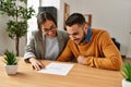 Couple smiling happy reading document at the office Royalty Free Stock Photo