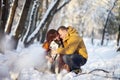 Couple smiling and having fun in winter park with their husky dog Royalty Free Stock Photo