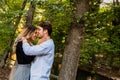 Couple of smiling lovers walk in a park