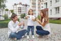 Happy family in front of new apartment building