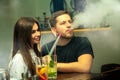 Couple smokes shisha at the bar Royalty Free Stock Photo