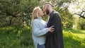 The couple is snogging in the green spring nature on sunset