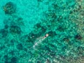 Couple snorkeling in the blue sea ocean and coral background aerial top view