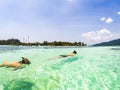 couple snorkeling in clear blue sea Royalty Free Stock Photo