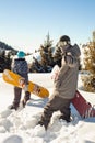 Couple snowboarder goes through deep snow in the mountain