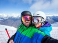 Couple snowboarders doing selfie on camera