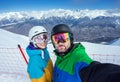 Couple snowboarders doing selfie on camera