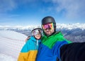 Couple snowboarders doing selfie on camera