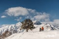 Couple of snowboarders standing on the snow hill Royalty Free Stock Photo