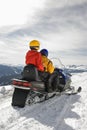 Couple on snowmobile. Royalty Free Stock Photo