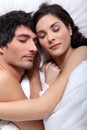 Couple snuggling in bed Royalty Free Stock Photo