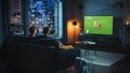 Couple of Soccer Fans Relax on a Couch, Watch a Sports Match at Home in Stylish Loft Apartment Royalty Free Stock Photo