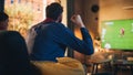 Couple of Soccer Fans Relax on a Couch, Watch a Sports Match at Home in Stylish Loft Apartment Royalty Free Stock Photo