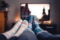 Couple with socks and woolen stockings watching movies or series on tv in winter. Woman and man sitting or lying together on sofa. Royalty Free Stock Photo