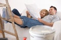 Couple on sofa looking at home renovation plan