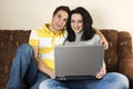 Couple on sofa using laptop Royalty Free Stock Photo