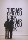 Couple in Solomon R Guggenheim Museum of modern and contemporary art in New York during Christopher Wool exhibition