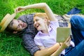 Couple soulmates at romantic date. Couple in love spend leisure reading book. Man and girl lay on grass relaxing