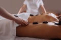 Couple in spa salon having hot stone massage Royalty Free Stock Photo