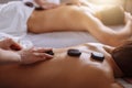 Relaxed Couple Receiving Hot Stone Therapy At Beauty Spa Royalty Free Stock Photo