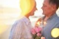 Couple, sparkler and date to celebrate love, birthday and vacation or holiday at beach in summer. Senior man and woman Royalty Free Stock Photo