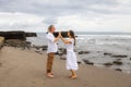 Couple spending time on the beach. Walking barefoot. Man and woman holding hands. Relation between husband and wife. Romantic Royalty Free Stock Photo