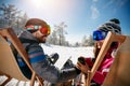 Couple spending time together and drink after skiing in cafe at Royalty Free Stock Photo