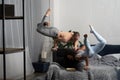 Couple spending time together reading book and making acrobatic balance at home. concept of self-development and Royalty Free Stock Photo