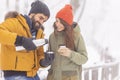 Couple spending snowy day outdoors drinking hot tea Royalty Free Stock Photo